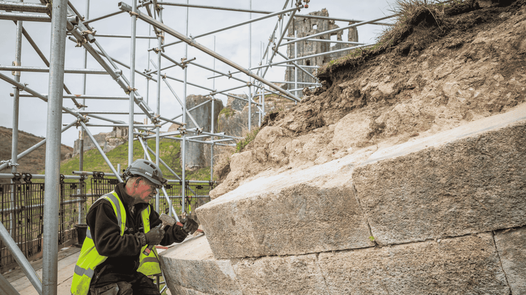 Stonemason conserving a fallen tower at Corfe Castle